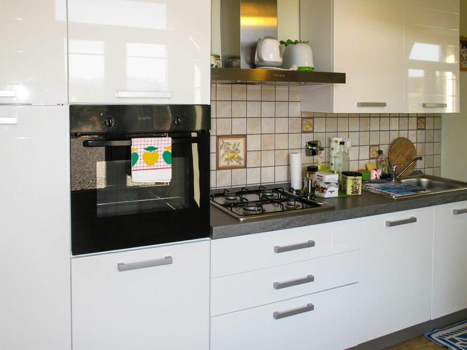 Countertop, Cabinetry, Room, Kitchen, Furniture, Property, Yellow, Interior Design, Major Appliance, Kitchen Stove