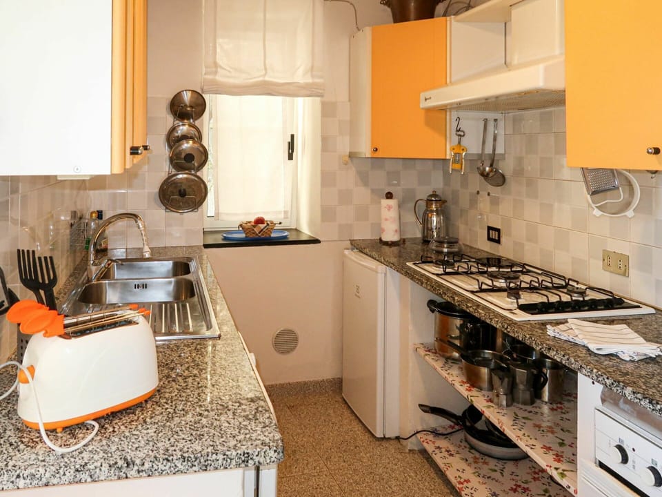 Countertop, Room, Property, Kitchen, Furniture, Cabinetry, Interior Design, Tile, Yellow, Floor