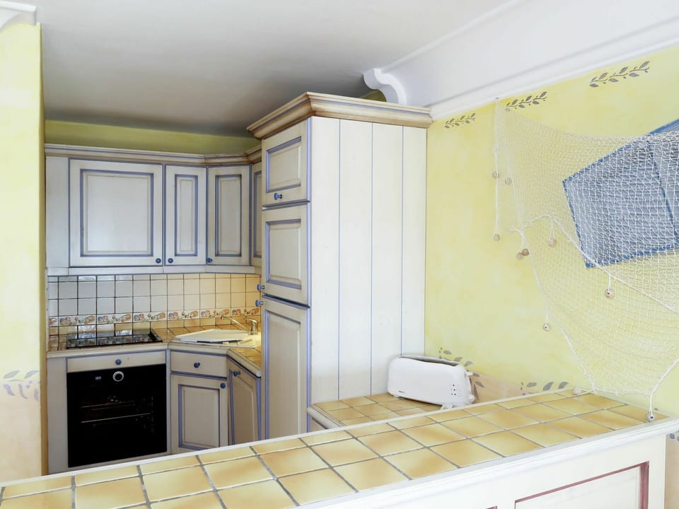 Room, Property, Tile, Kitchen, Interior Design, Cabinetry, Furniture, Yellow, Countertop, Ceiling
