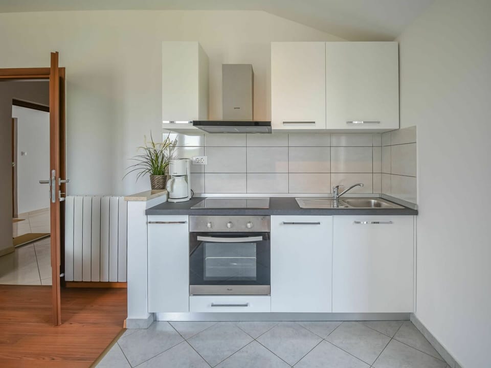 Room, Kitchen, Furniture, Property, Cabinetry, Kitchen Stove, Countertop, Floor, Major Appliance, Tile