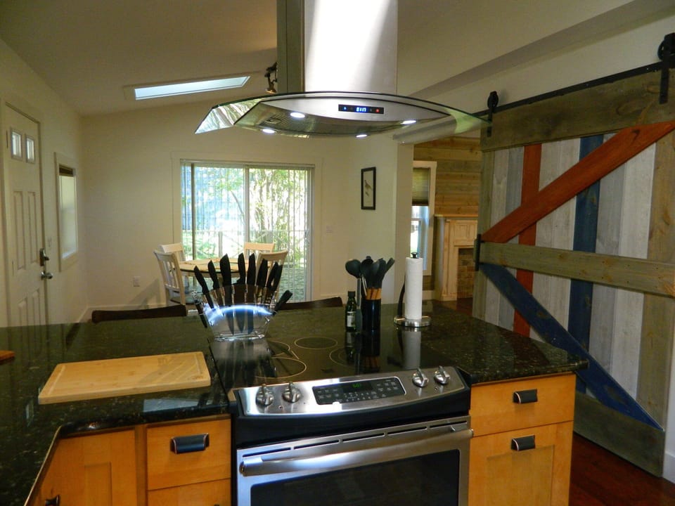 Full sized glass top range and refrigerator.