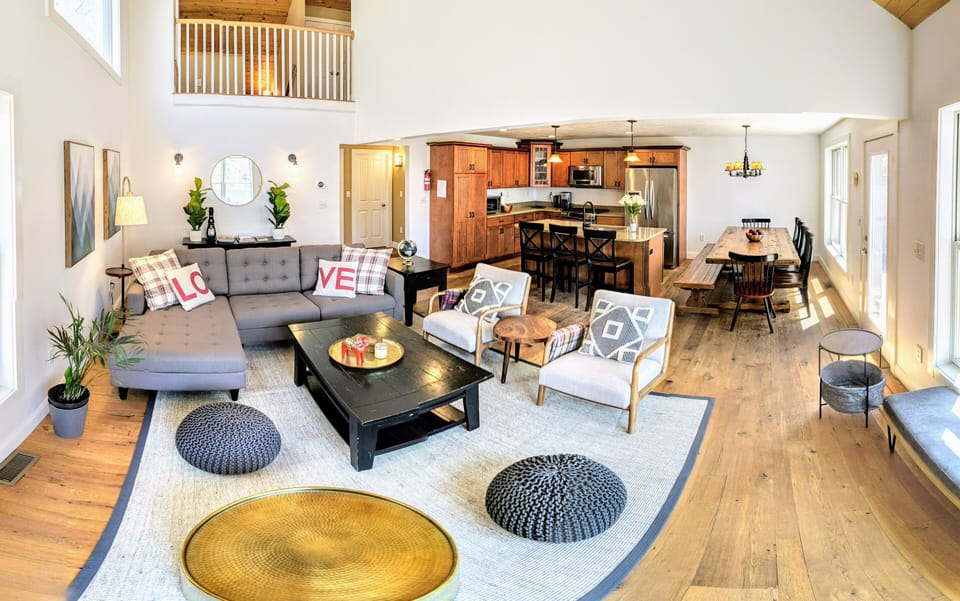 2nd floor living room with kitchen and dining table in the back