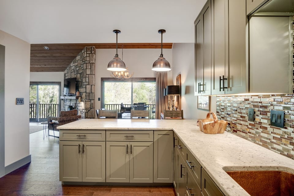 Beautiful, high-end kitchen with granite countertops, copper sink, lake view