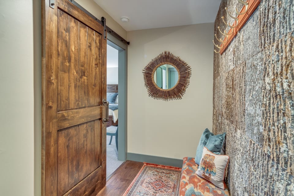 Entry foyer with lovely decorator accents including a bark wall and barn door