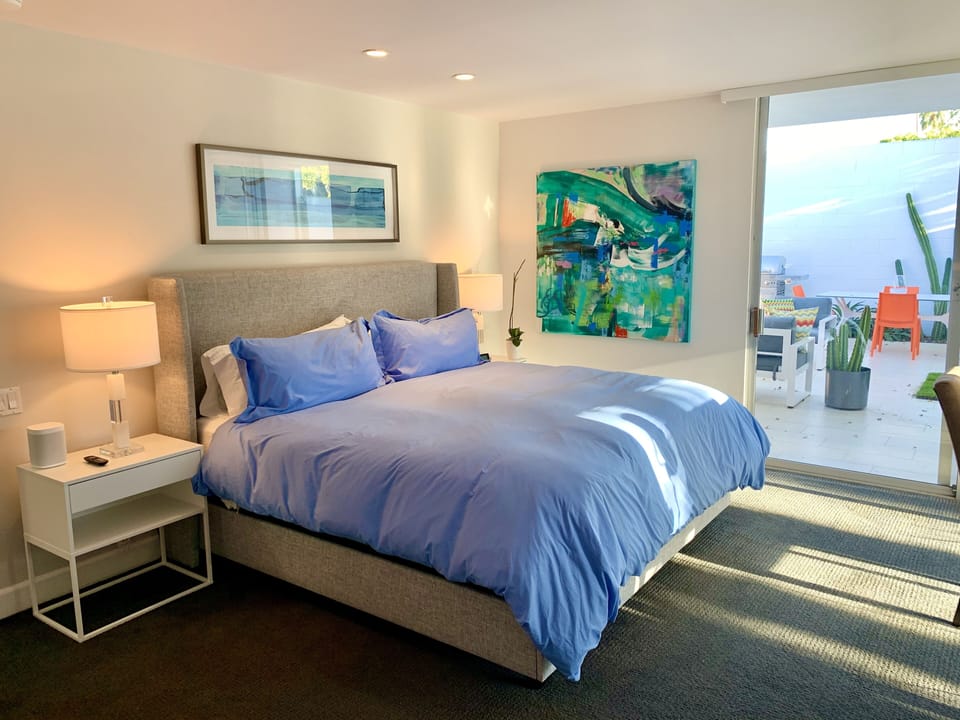 Guest room with huge windows on to the private patio and overlooking the pool