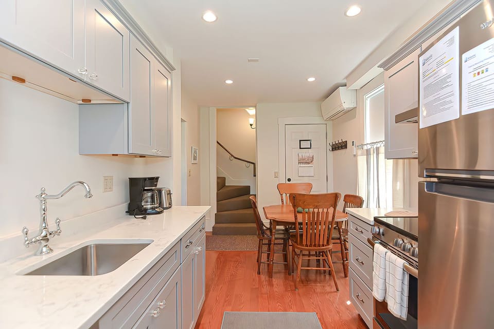 The staircase off of the kitchen leads to the second floor.