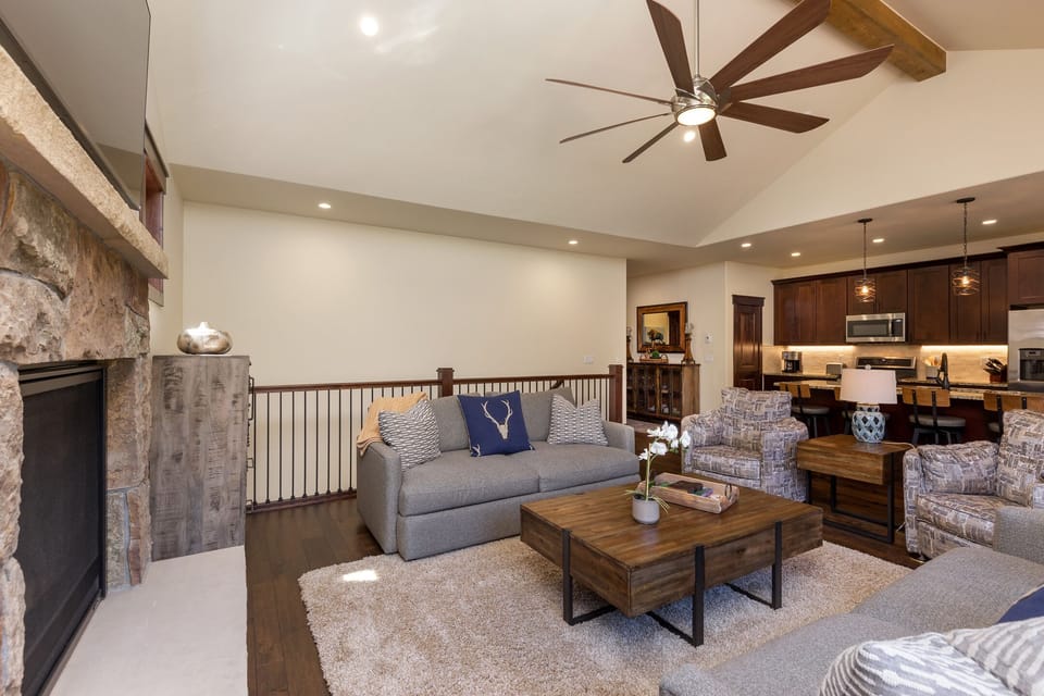 Relax in your spacious living area with vaulted ceilings, cozy fireplace, and open kitchen perfect for gathering with loved ones.
