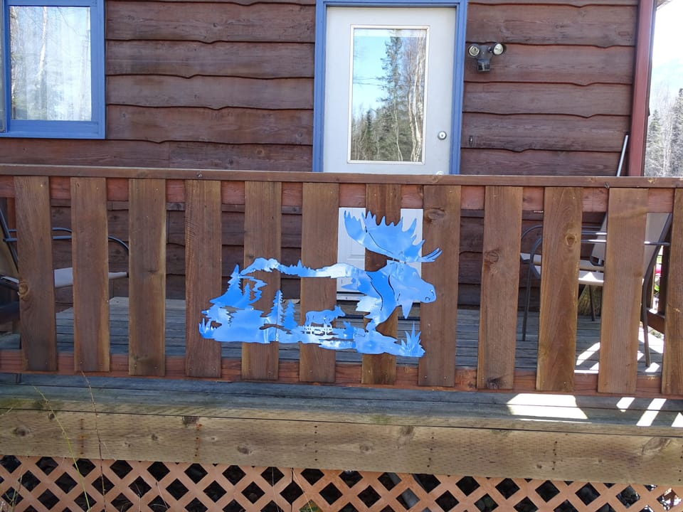 Small deck with chairs and barbecue. 
