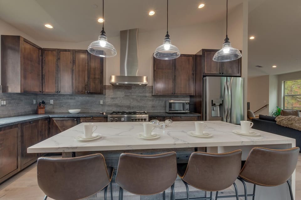 - Stylish kitchen with pendant lighting above island  
- Four leather barstools create a cozy breakfast bar  
- Perfect for entertaining after Lake Tahoe adventures