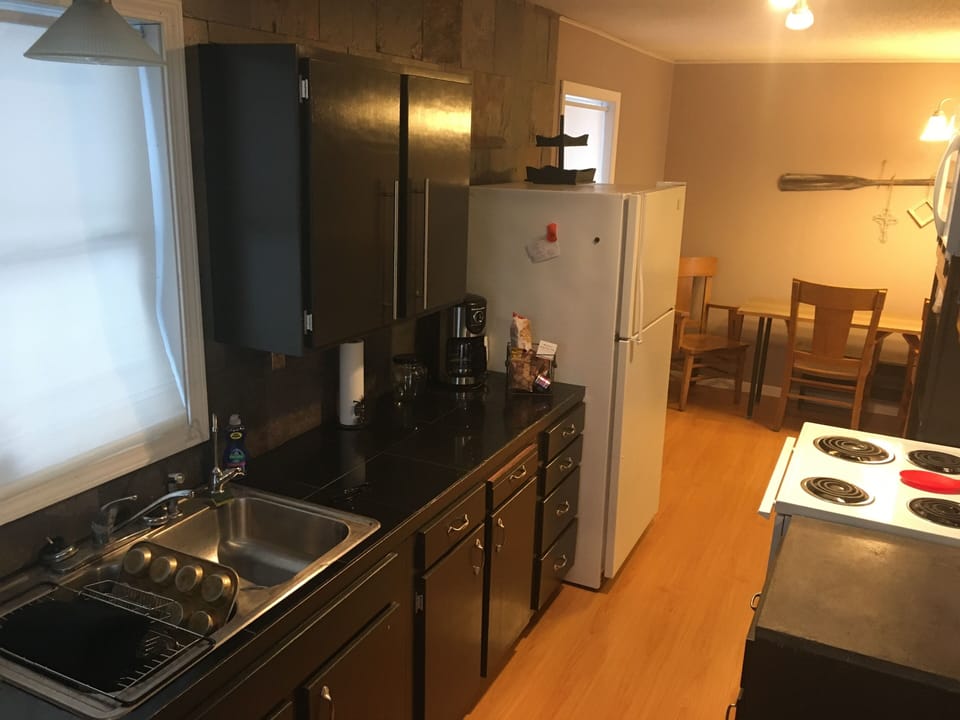 Kitchen w/ pans/dishes, microwave, coffee pot w/filters, toaster etc supplied. 