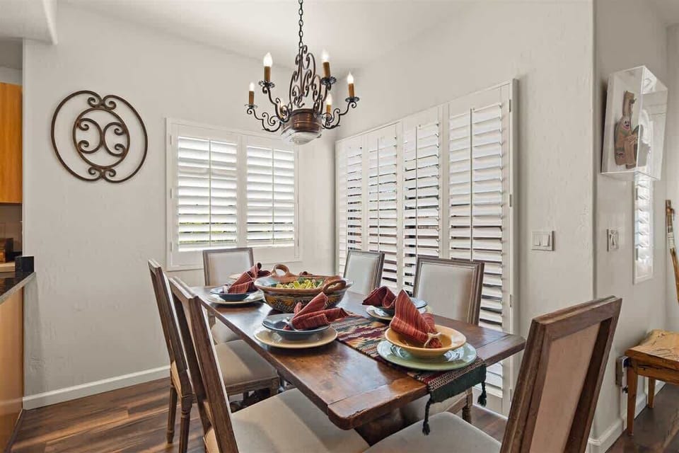 The dining table seats 6 guests with additional seating for 2 at the kitchen counter