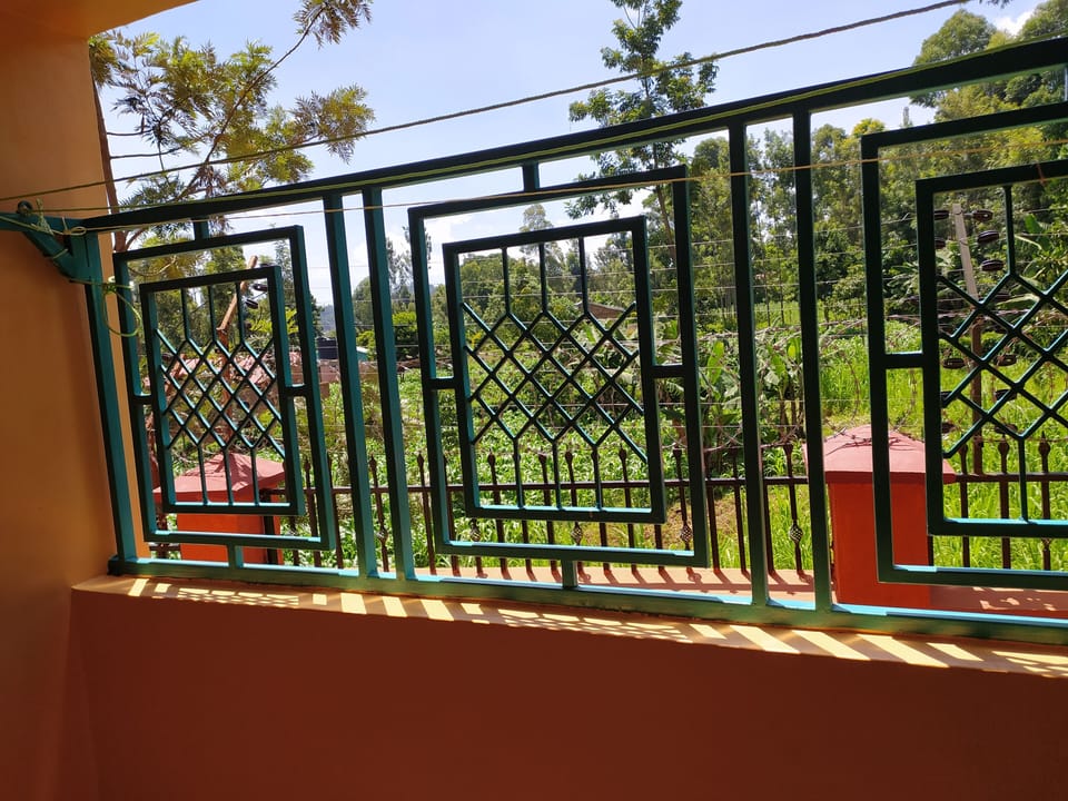 Back balcony overlooking a garden, provides fresh air and good site.