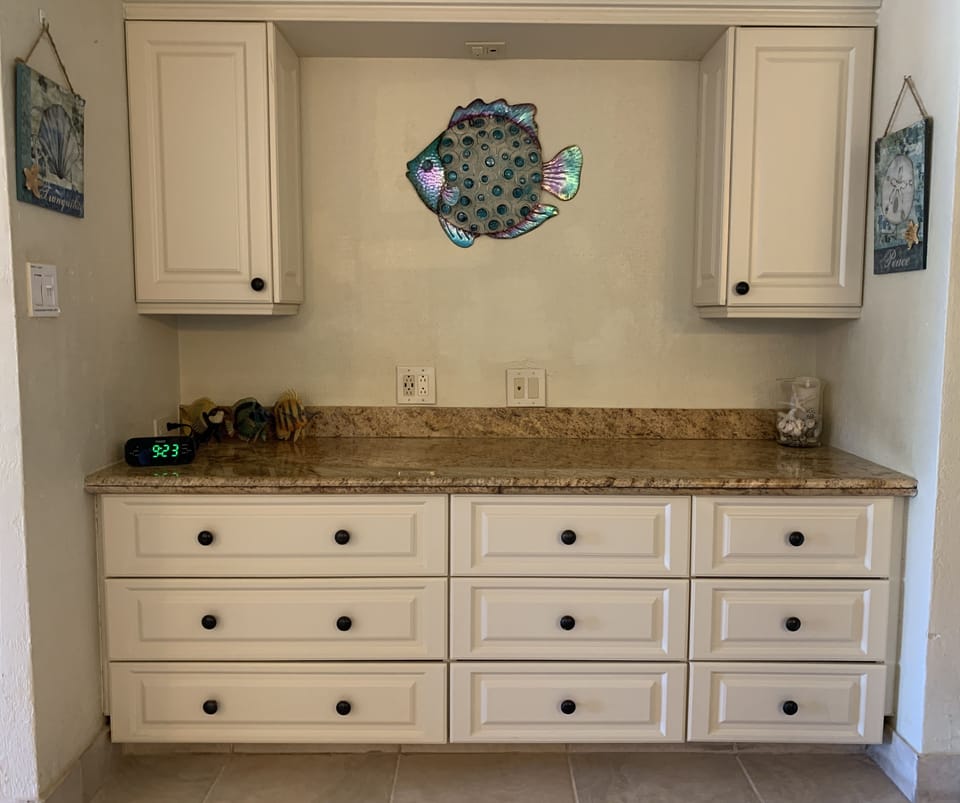 Big dresser and granite top that goes wall to wall so nothing falls behind it ;)