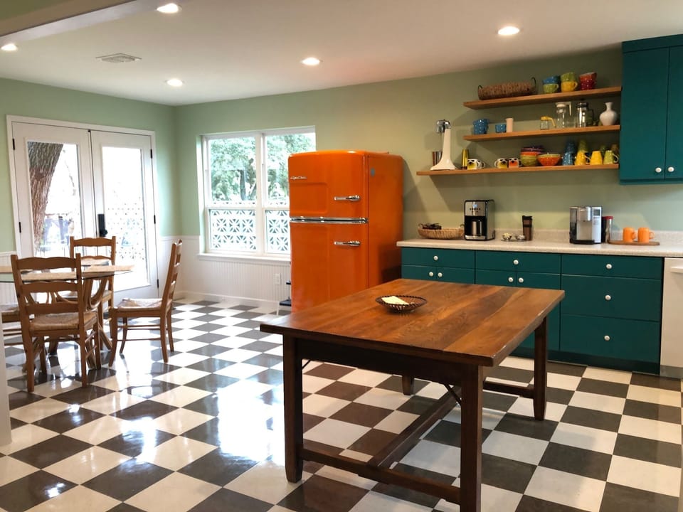 Main house kitchen with door to deck and grill