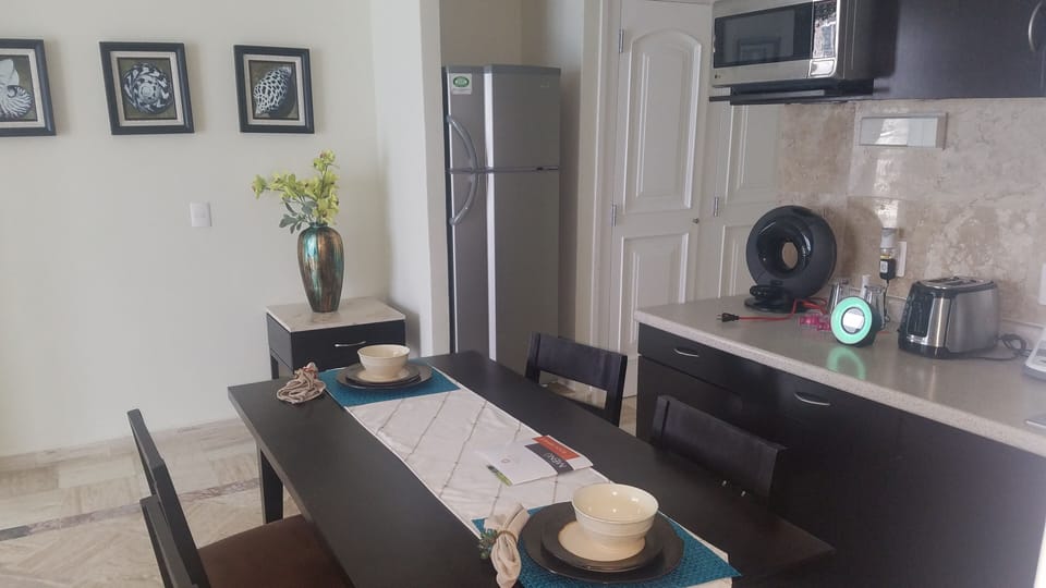 Microwave, full refrigerator, sink, dinning table