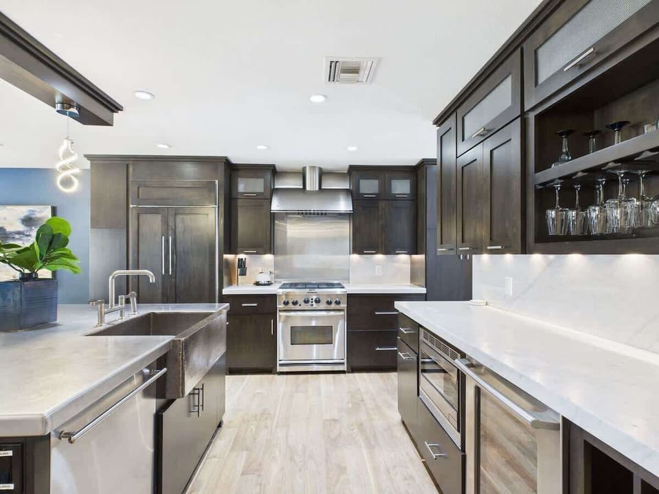 Fully equipped kitchen with stainless steal appliances and a kitchen island with bar seating for 3 guests.