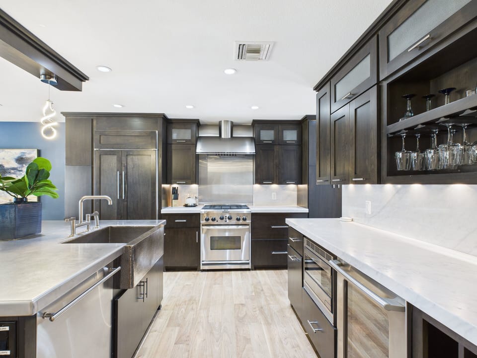 Fully equipped kitchen with stainless steal appliances and a kitchen island with bar seating for 3 guests.