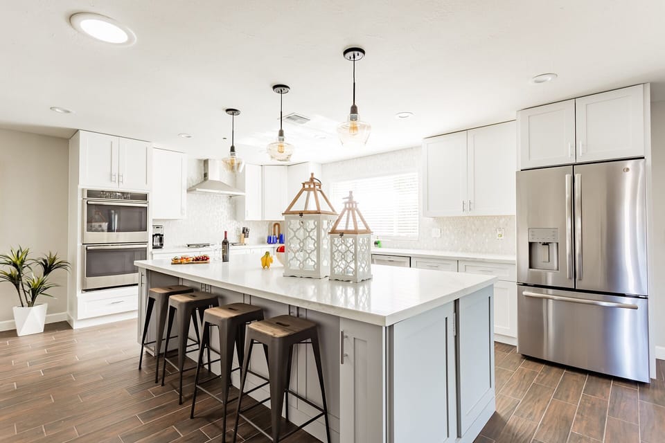 Fully equipped kitchen stocked with your basic cooking essentials and stainless-steel appliances, bar seating, and is connected to the dining area with ample seating.