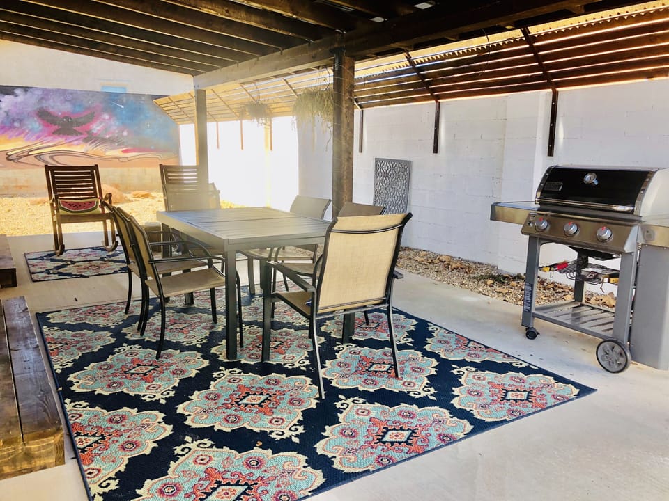 Beautiful shaded patio with dining table and BBQ and Rocking chairs.
