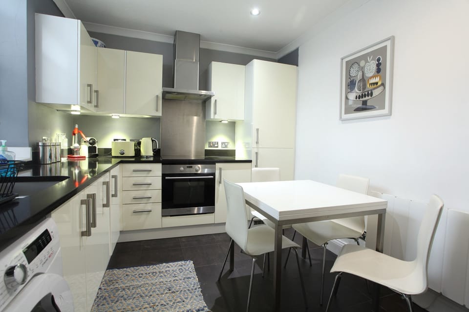 Full kitchen with dining table and chairs