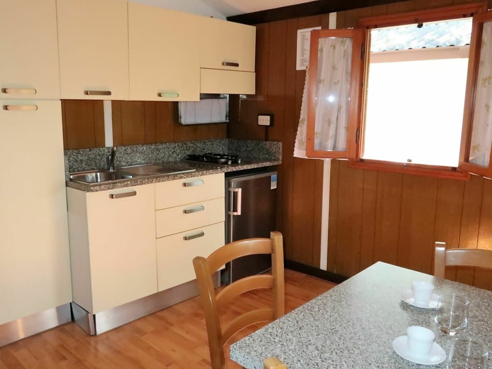 Room, Countertop, Property, Furniture, Kitchen, Cabinetry, Building, Kitchen Stove, Floor, Major Appliance