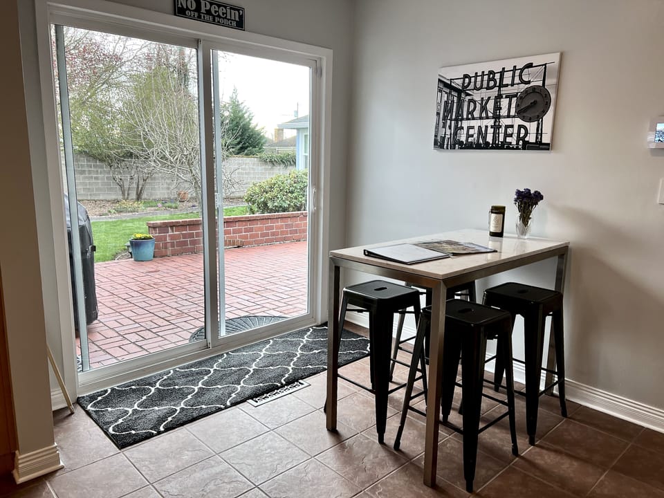 Kitchen seating with sliding door to back patio and yard.