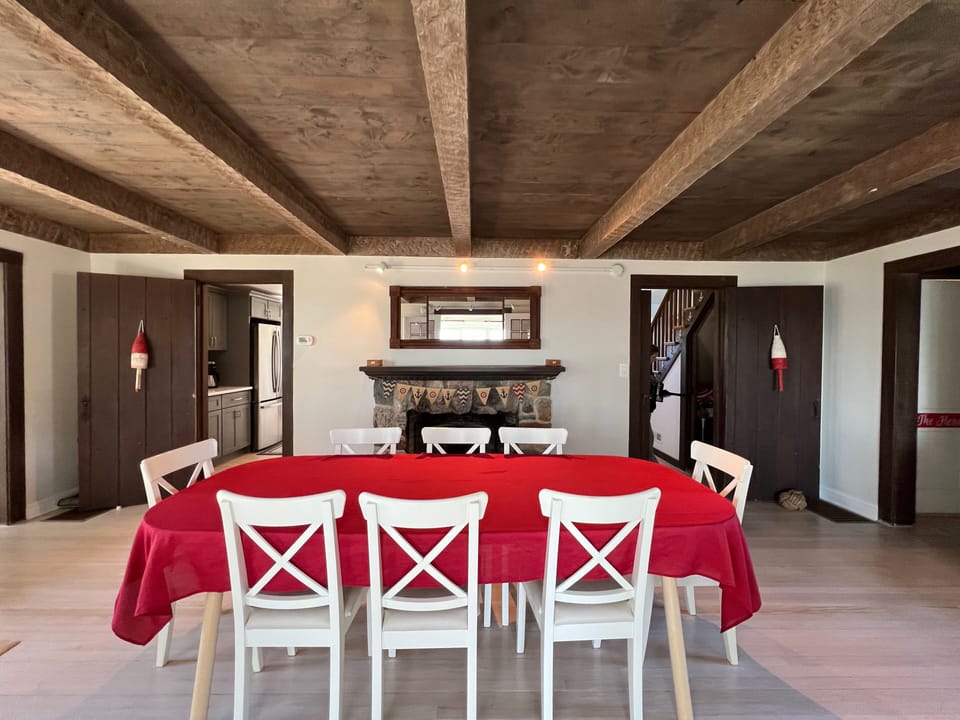 Dining room with stone fireplace. Plenty of table linens provided