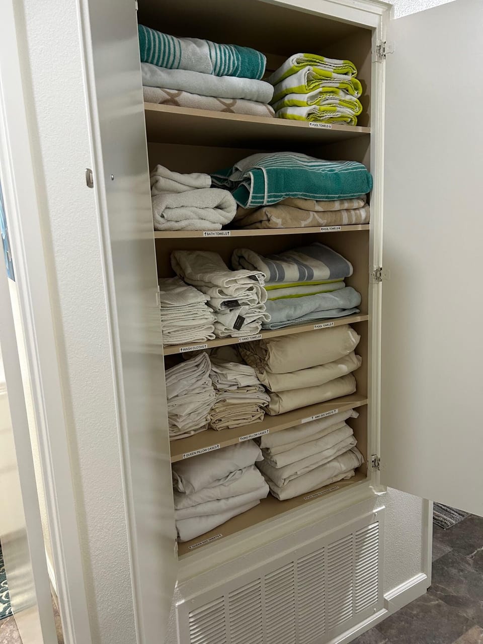 Hallway linen closet fully stocked