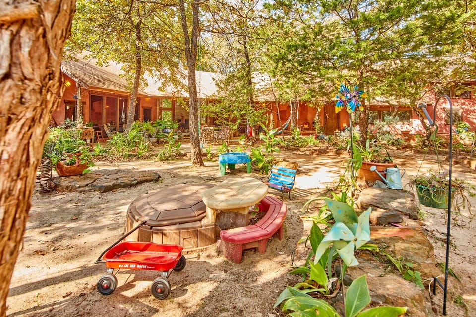 Toddler Play area with sandbox, Tonka trucks, swings, hammocks, red wagons, rock climbing… within view of Lodge outside living area.
