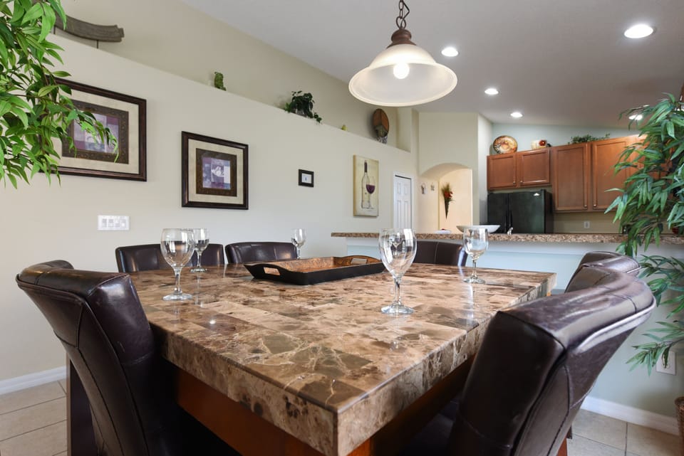 Elegant dining area with a marble-top table set for a family meal.