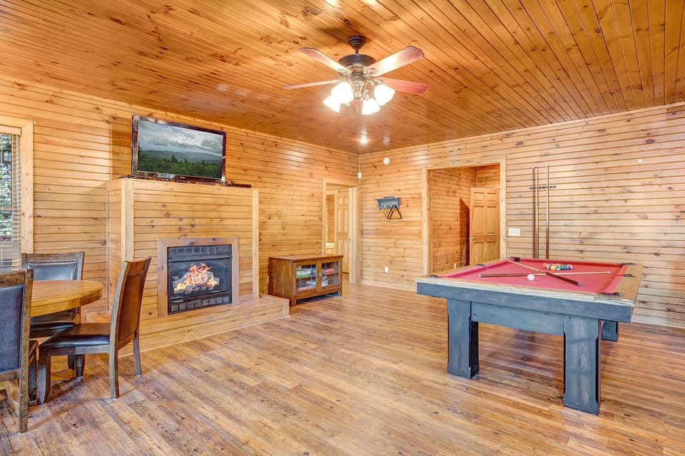 gas fireplace with sofa in game room and poker table