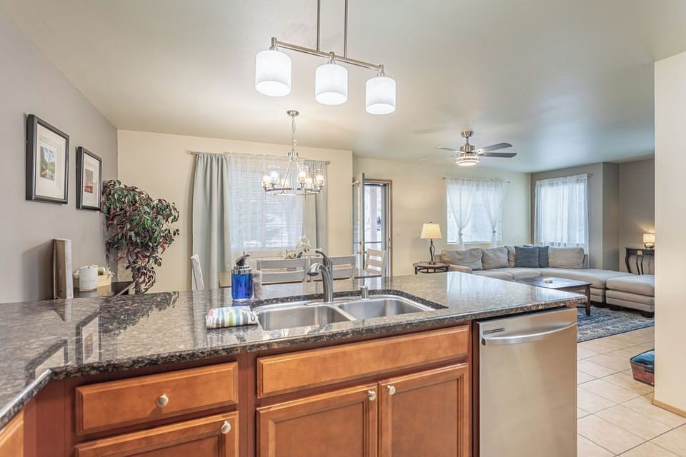 Open floor plan living, dining, kitchen opens up to the back grassy area.