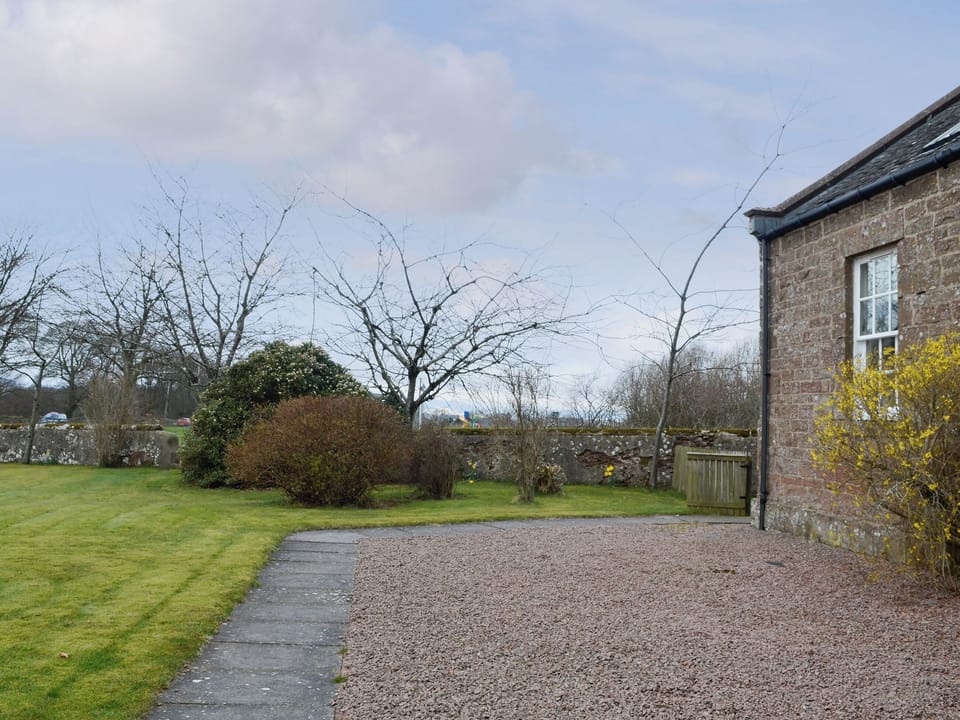 Gravelled and lawned areas surrounding the cottages