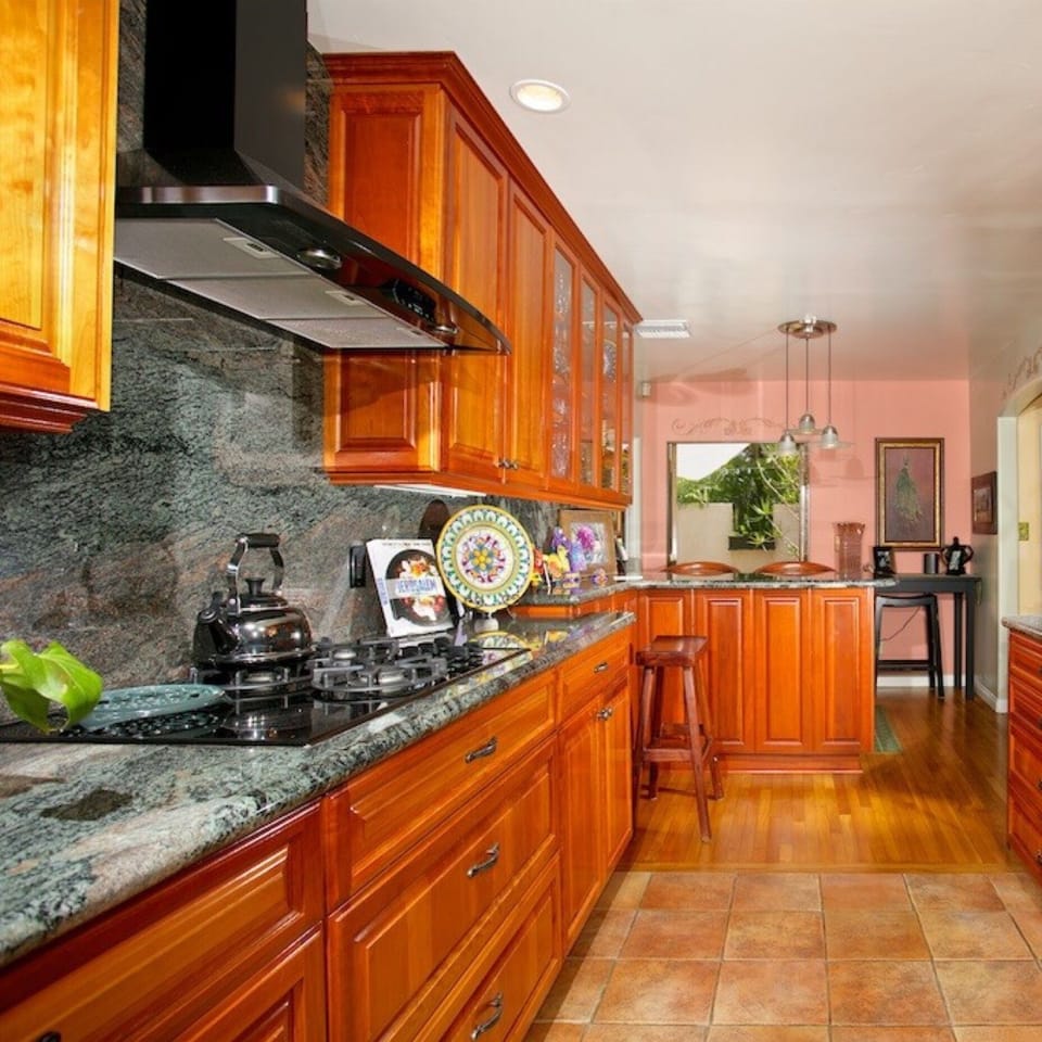 High end appliances. Doors open to patios on both sides of kitchen. 