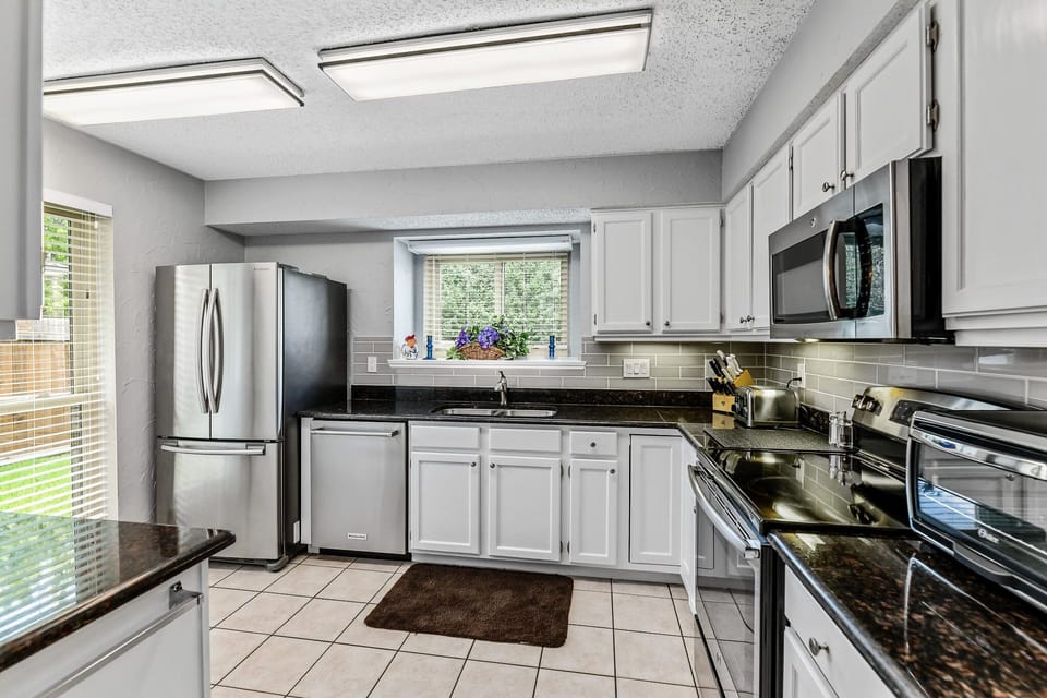 Bright kitchen with modern stainless steel appliances. 