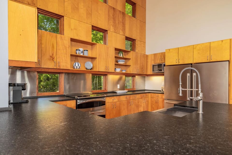Kitchen with double ovens, double refrigerators, dishwasher and large sink