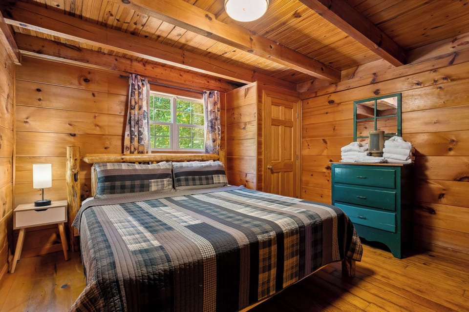 King bed + rustic warmth = restful nights after mountain adventures.