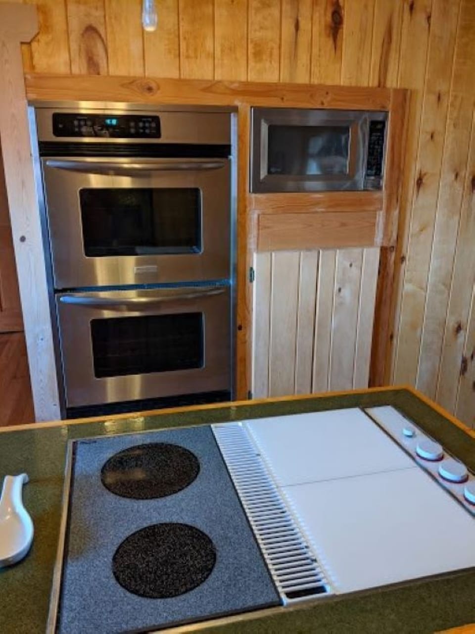 Kitchen with double oven, microwave and range in island