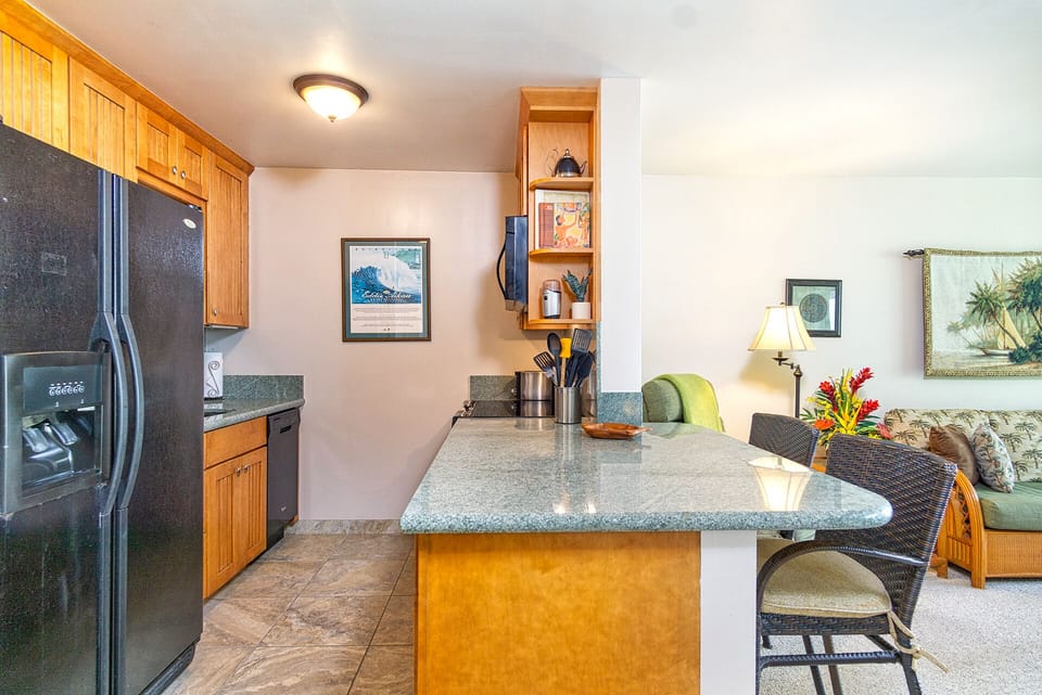 Tastefully updated kitchen with modern appliances and island-inspired décor — perfect for preparing meals.
