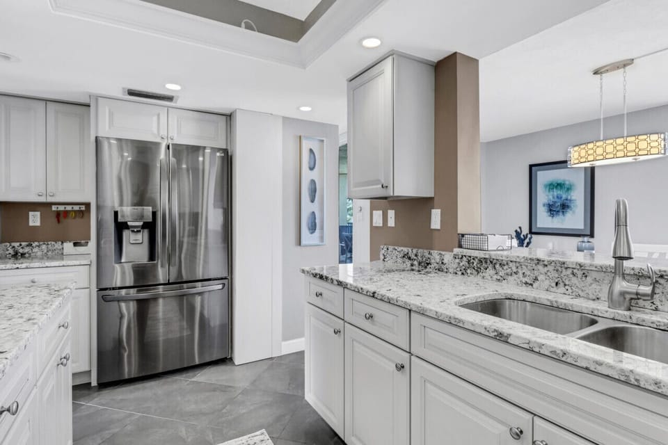 Kitchen overlooking dining area. Refrigerator with extra craft ice maker.