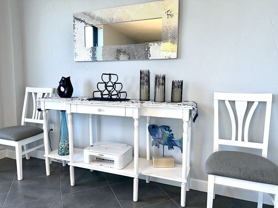 Additional chairs, printer and wine rack.