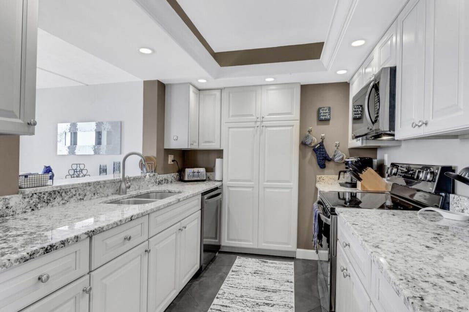 Kitchen with pantry and broom closet.