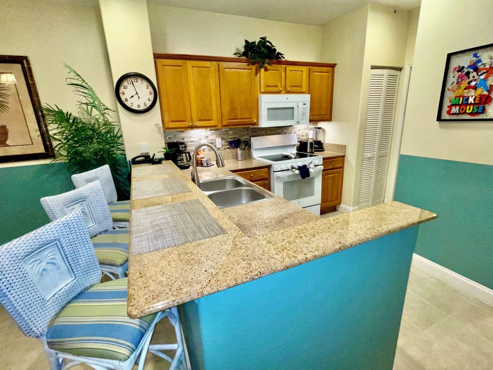 Kitchen with granite countertops & eat-in-bar