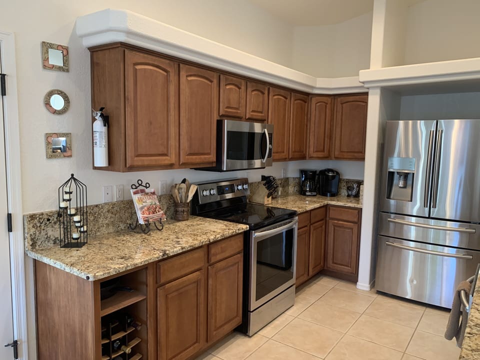 Kitchen with plates and glasses and utensils for 18!