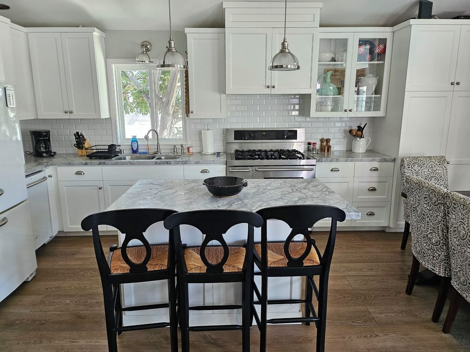 Kitchen seats 6 at table and 3 at the island.