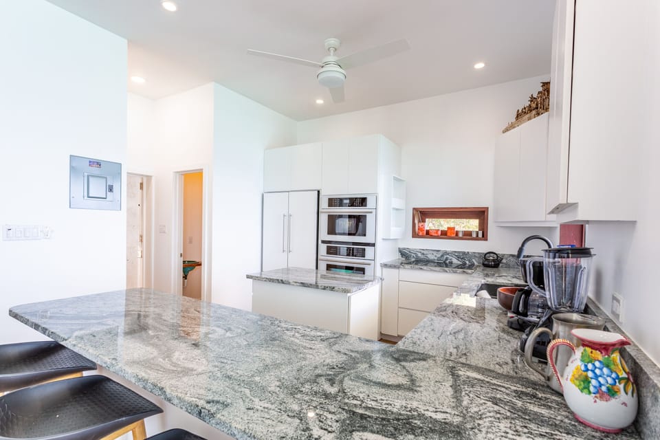 The sleek white kitchen is perfect for your wildest Caribbean concoctions