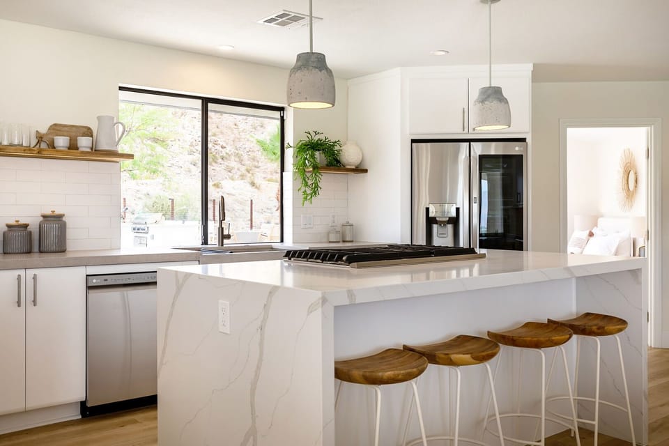 Waterfall marble counter tops show the luxury and detail exemplified through out the newly remodeled home! Island seating for 4.