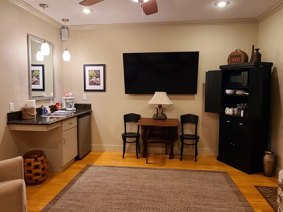 Living room/kitchenette with microwave, mini-fridge, sink, and coffee maker. 