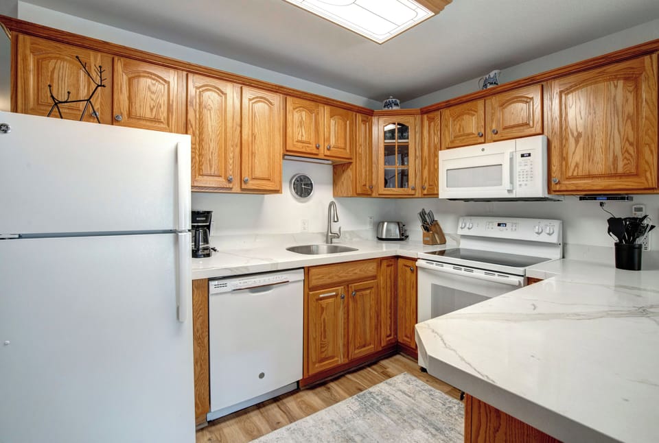 Your fully equipped kitchen features beautiful oak cabinetry, modern appliances, and everything you need to prepare meals during your stay.