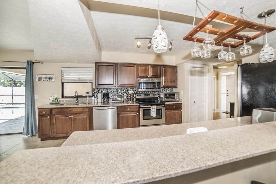 Our large kitchen has a direct access to the pool and patio